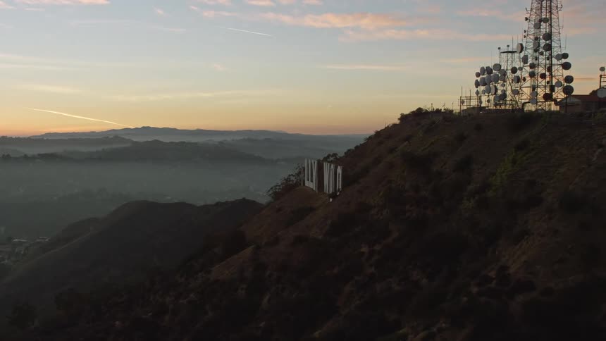 The iconic hollywood sign stands out upon a mountain over los angeles