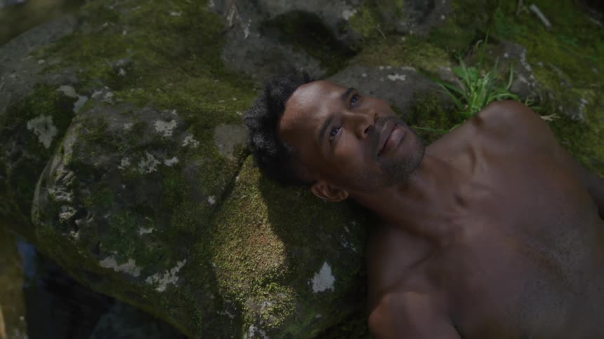 A man is laying on rocks