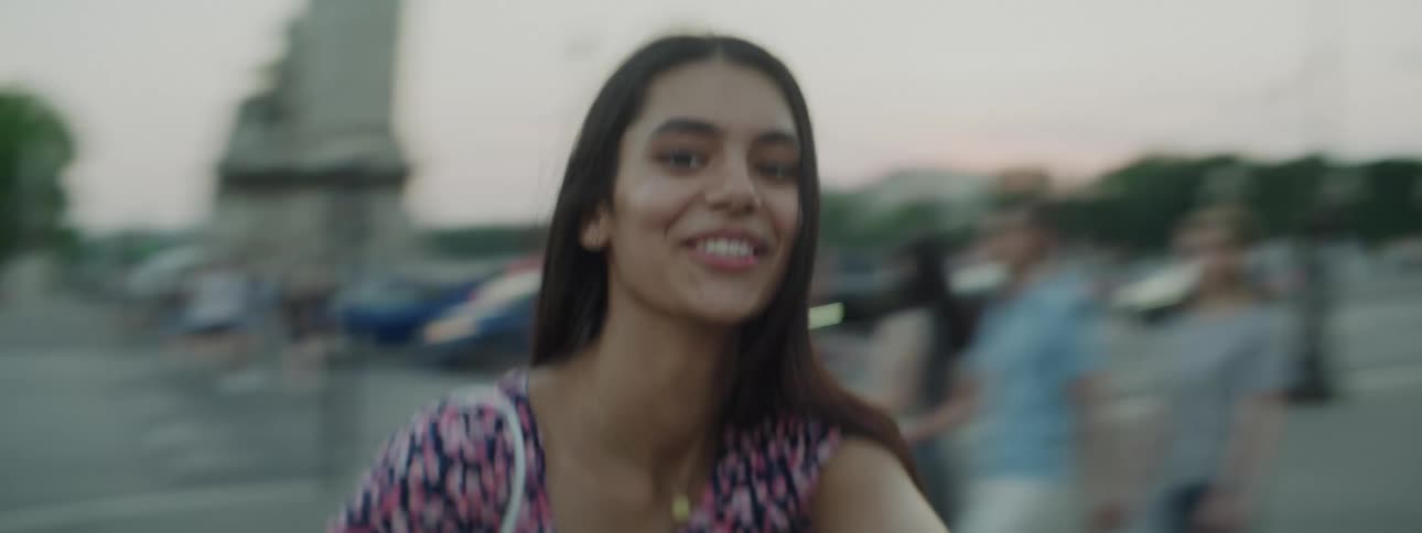 Portrait of a woman in selfie spinning while in a public setting