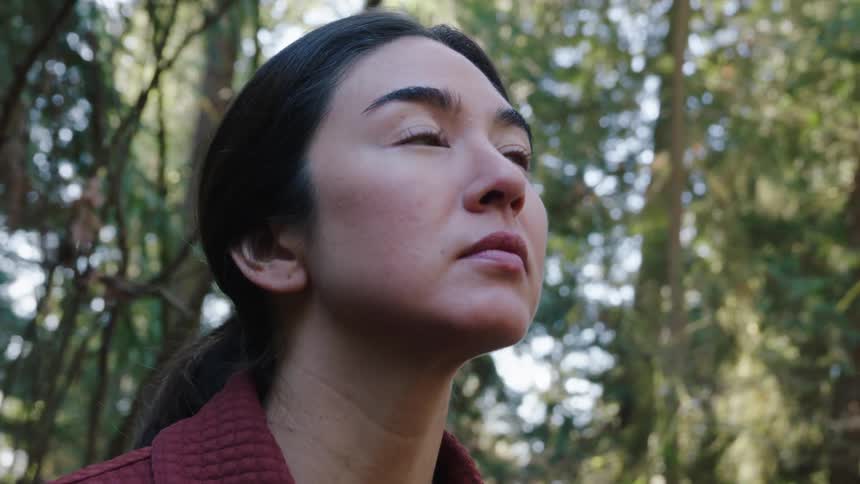 Woman looking around in woods