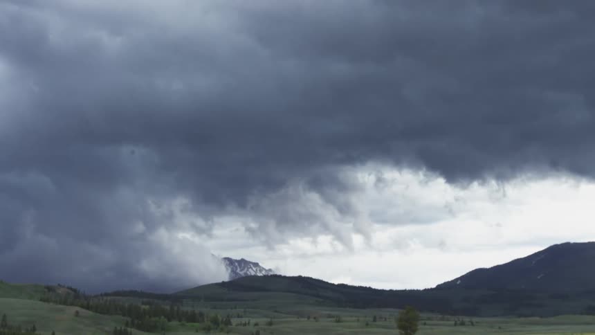 Storm clouds moving into a mountain valley