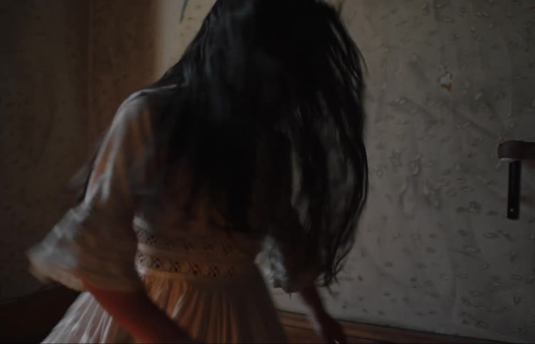 A little girl in a dress and a little boy are spinning together