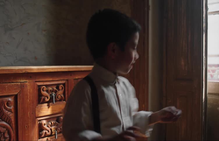 Two children spin around in the room together