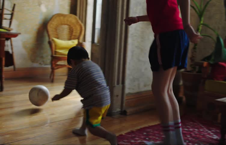 Brothers play soccer at home