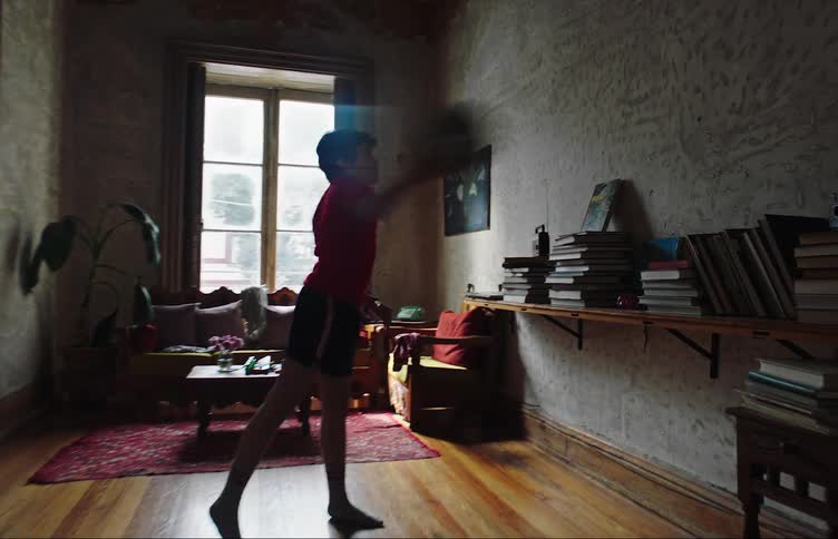 A child throws the soccer ball against the wall