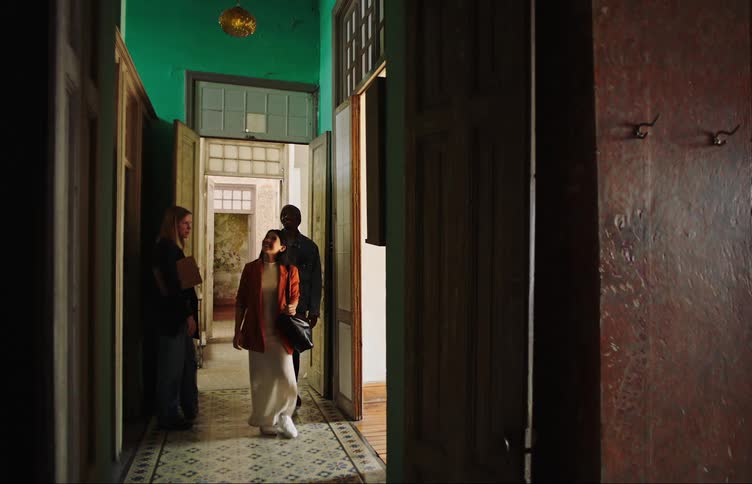Real estate agent woman presenting a property to a couple happily watching