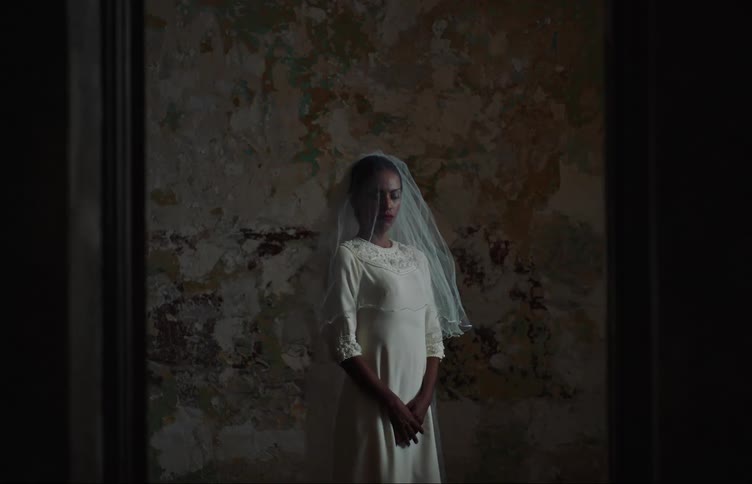 A young bride stands in a room