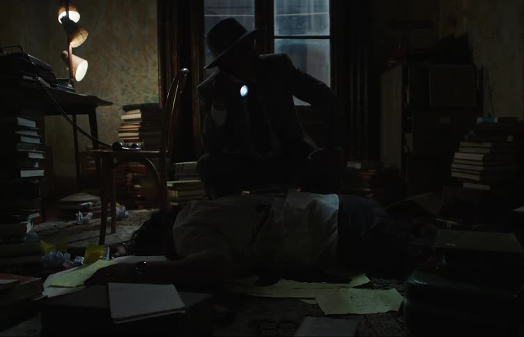 Detective with a flashlight inside a room investigating a body of a dead man with a bloody shirt