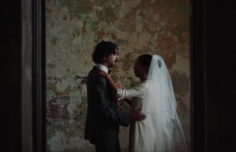 Newlyweds dance in a room