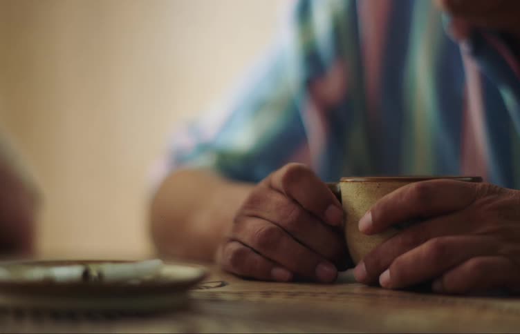 A man holds his coffee cup