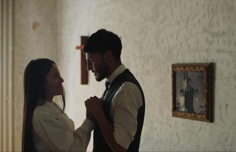A man and woman hold hands and talk