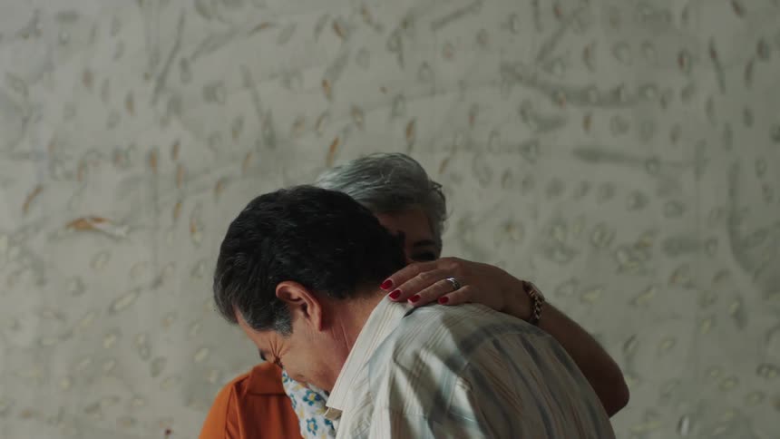 A couple are dancing at home