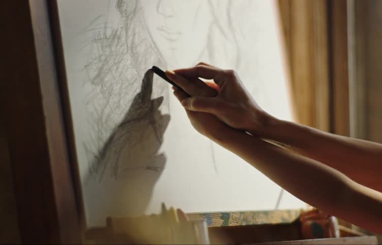 A woman teaching a child how to draw a portrait