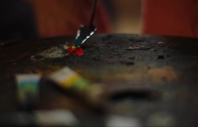 A clip of a person mixing paints