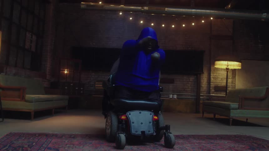 A black man in a wheelchair dances