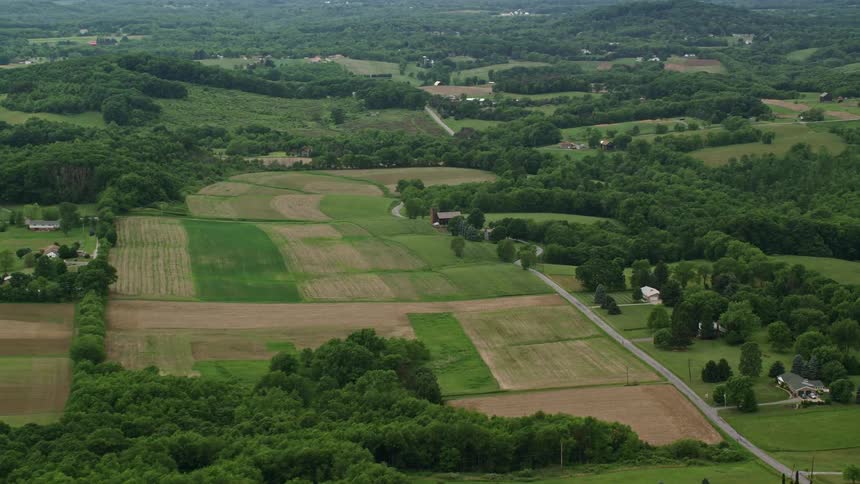 The landscape is full of trees and spread out homes