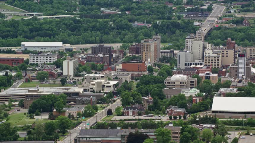 An aerial clip of a city filled with buildings and vegetation