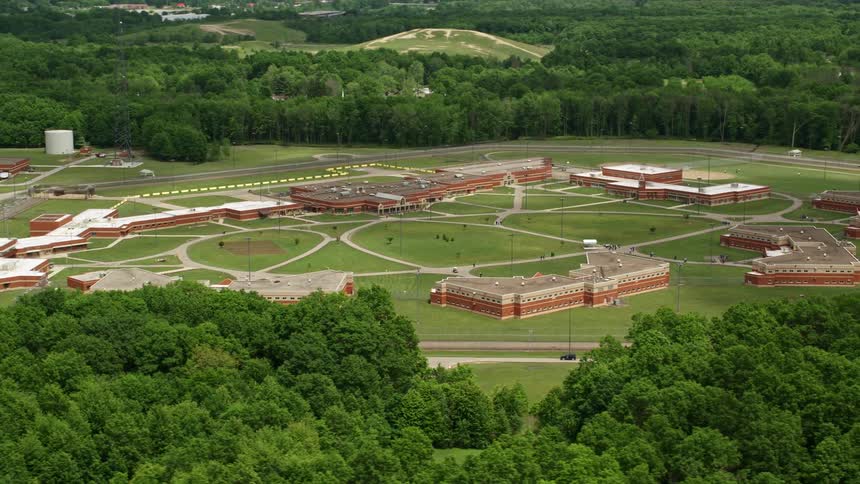 A large facility surrounded by a forest
