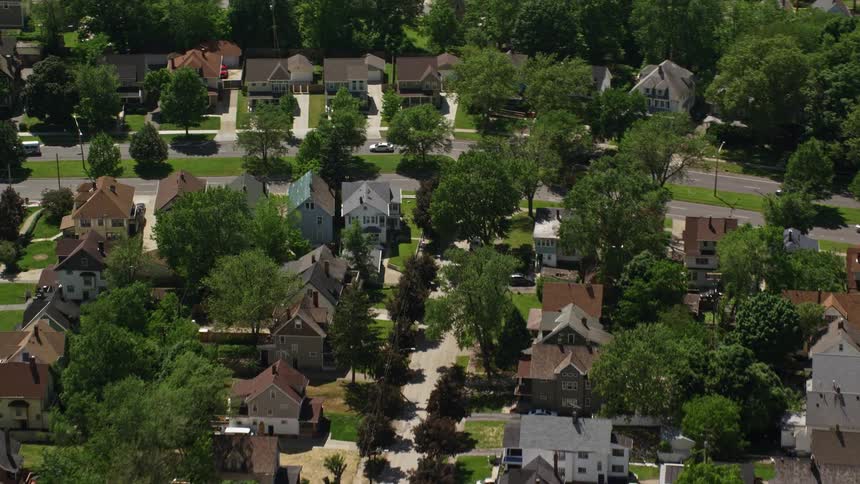 An aerial footage of a neighborhood filled with vegetation