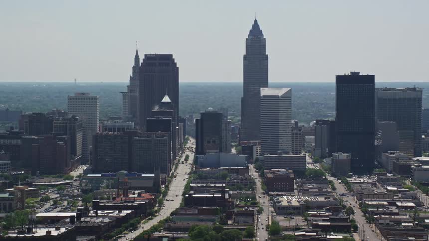 A skyscraper towers over a bustling city center