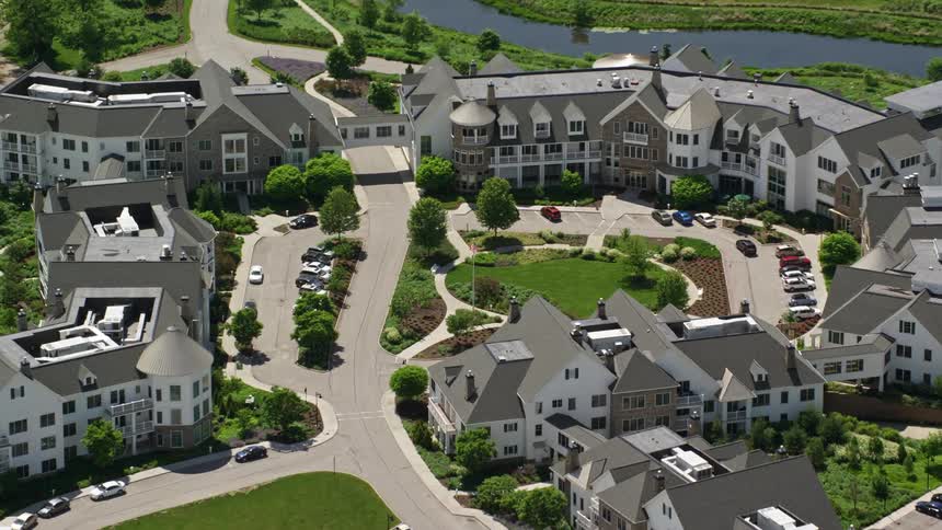 A large apartment complex near a forest