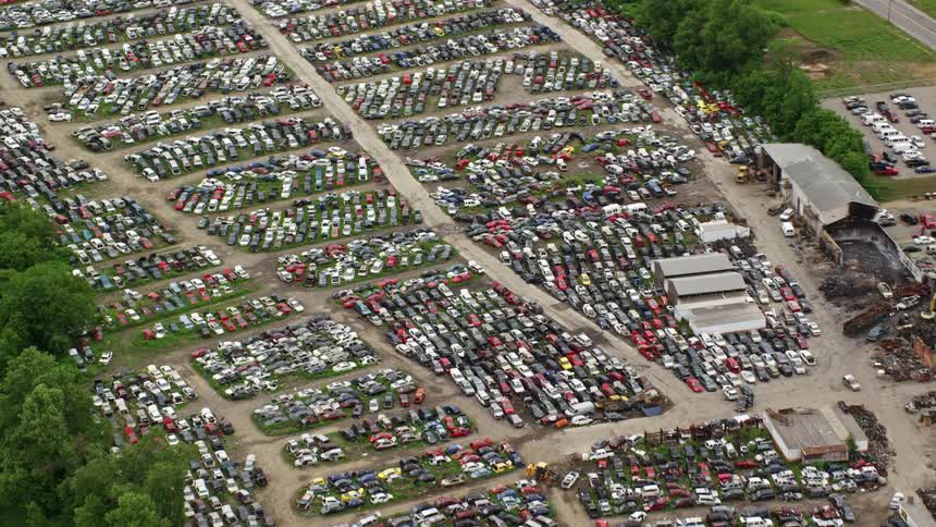 A huge parking lot is by the suburbs