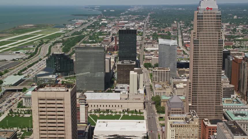 A skyscraper and building towers dominate a city center