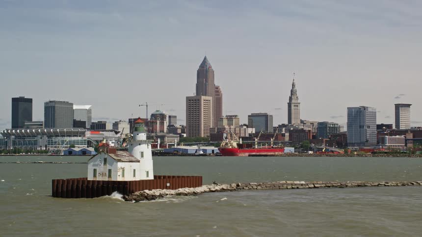 A lighthouse off the coast of a city