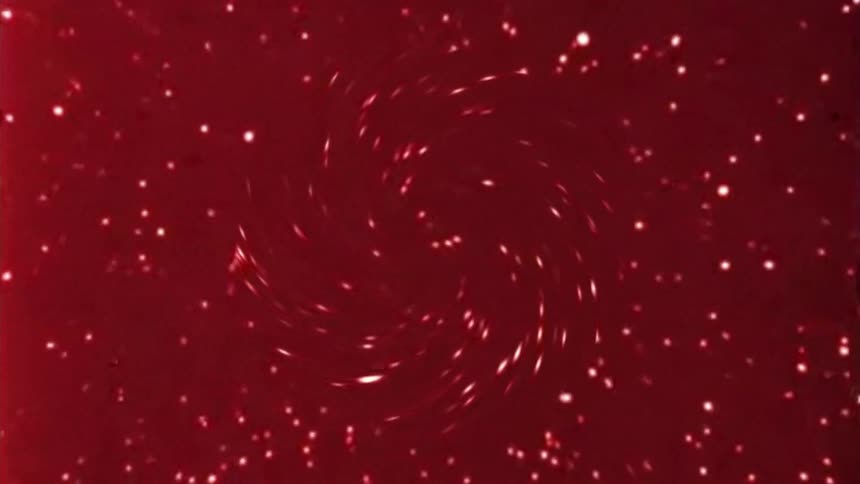 Whitish spiral on a reddish background moving in an abstract way