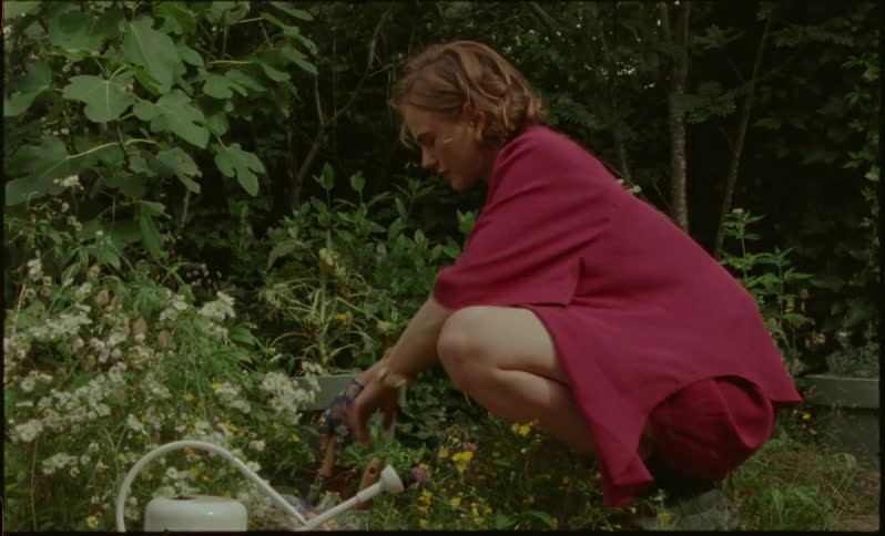 A woman is gardening outside while its spring time