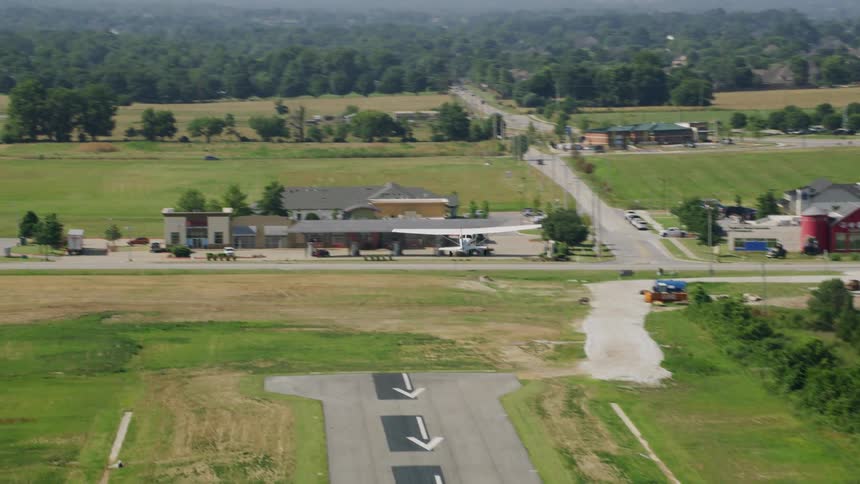 Small singleengine plane flying above the runway