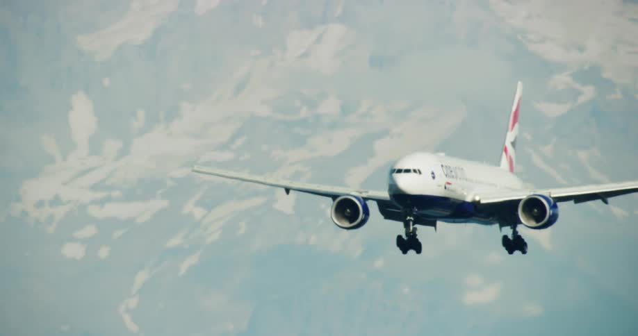 A plane flies over the mountains