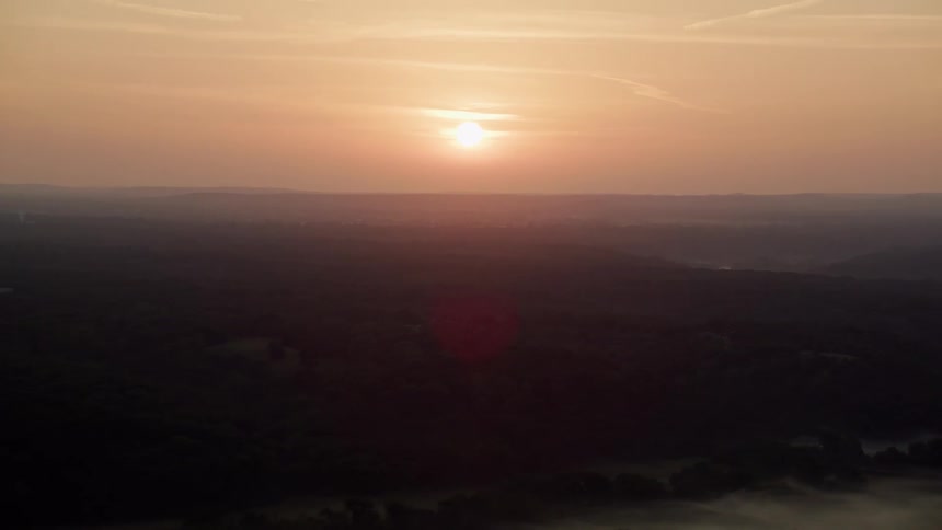 An aerial clip of the woods at dawn