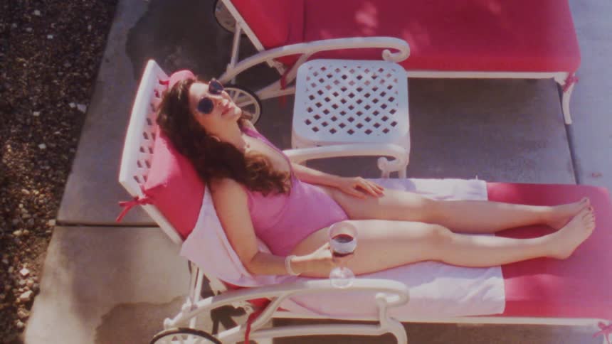 A woman is sunbathing on the chair