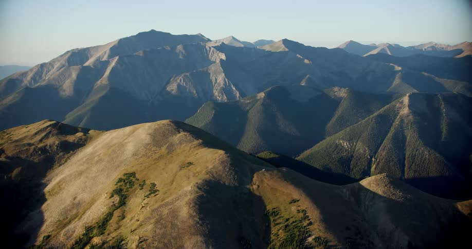 Tall mountains surround the landscape while the sun is setting