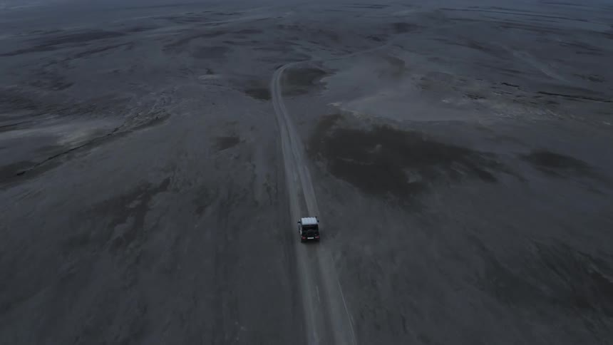 Vehicle is traveling on empty road in the mountains