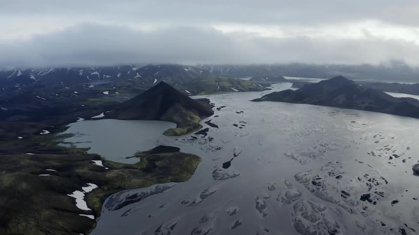 A large frozen bay near mountains