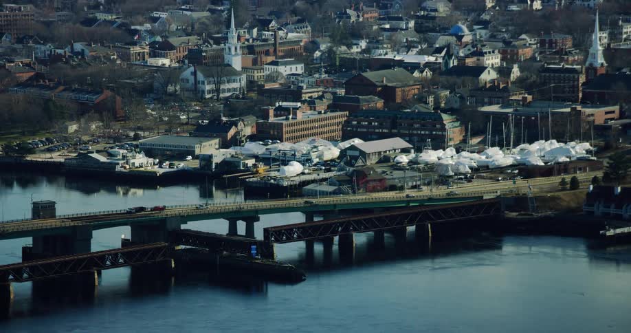 Aerial panorama of an urban city by the sea with an interconnecting bridge and vehicular traffic