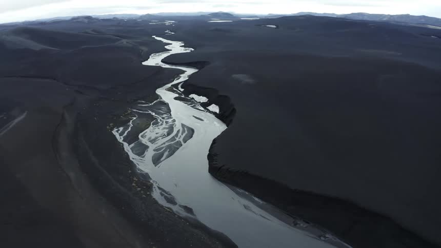 Narrow river flowing through the valley