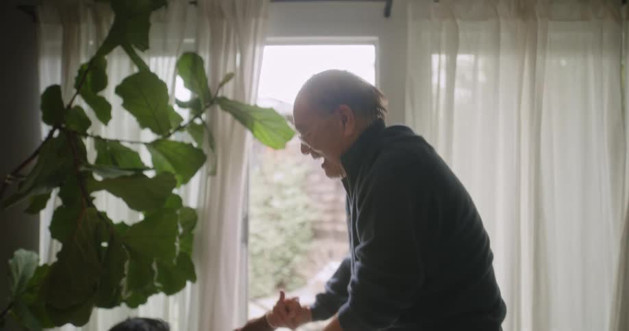 Man and woman sitting on the ground indoors holding hands together