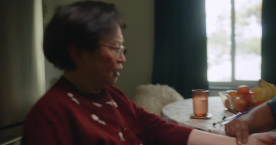 A healthcare worker feels a patients pulse