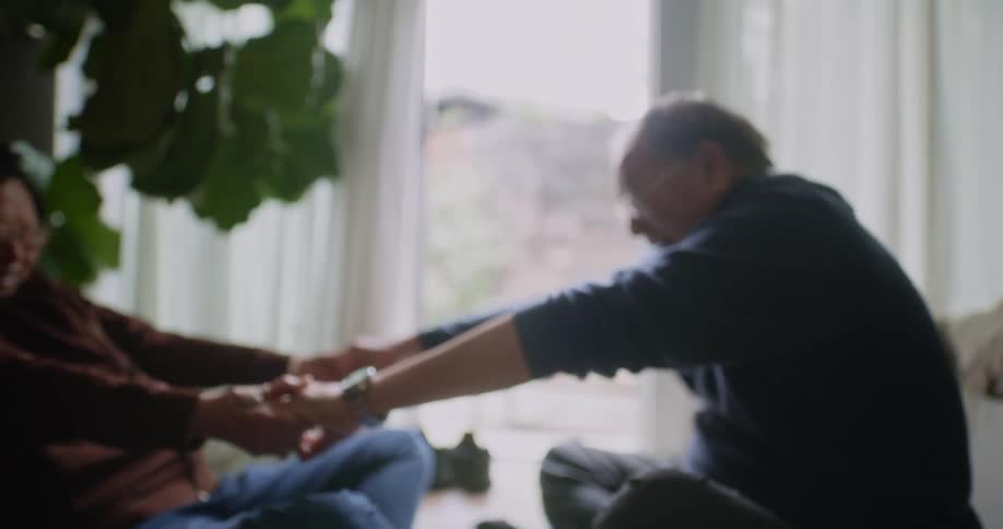 A couple are stretching together at home