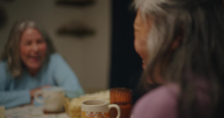 Friends talk at the kitchen table