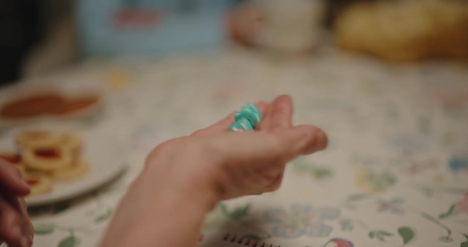Hand of a woman with two dice in her palms swinging in sequence playing on the table