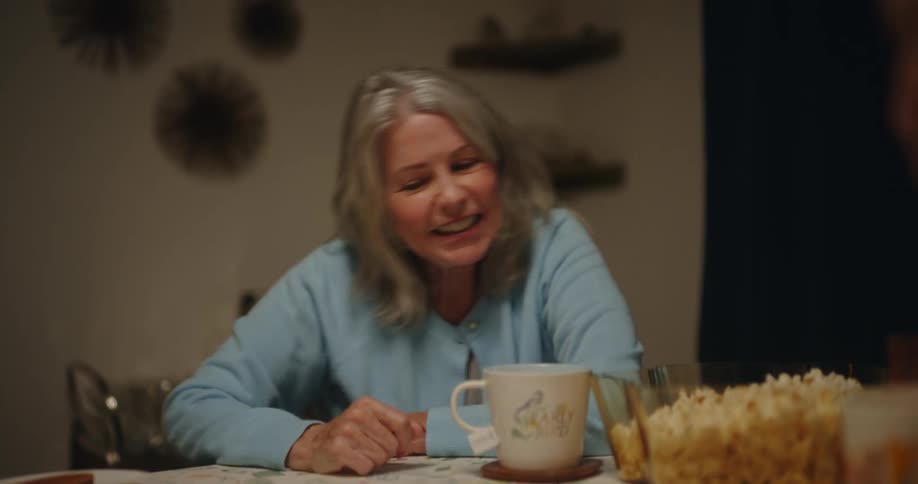 Friends sitting at a table with food drinking cup of coffee and playing dice