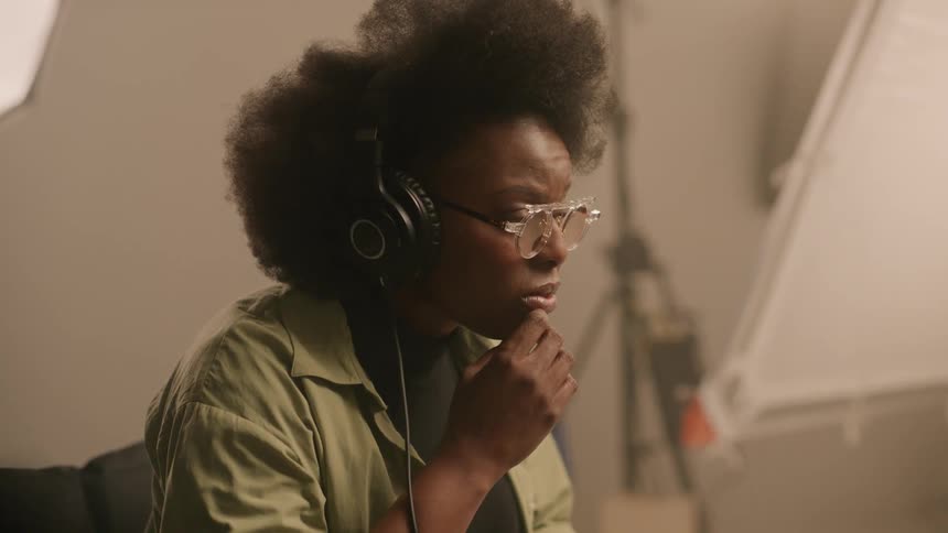 Woman with headphones concentrated inside a studio