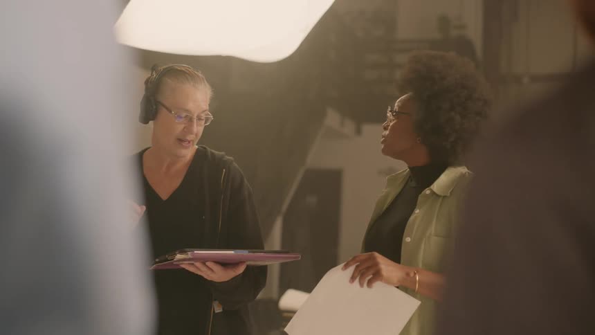 Two women discuss a script