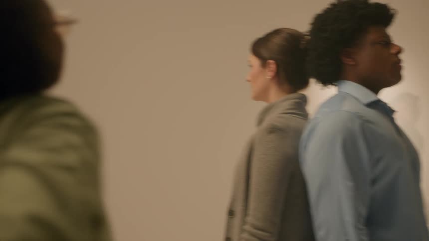 A director looking at two models standing back to back