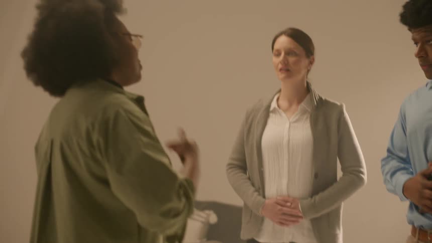A director working with two actors giving them direction