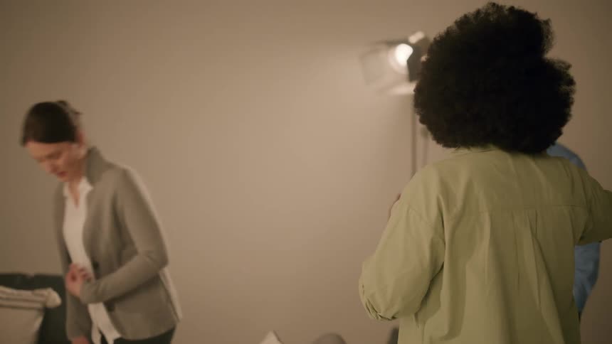 Three people talking together in a room